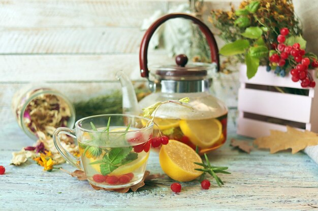 Vitamin tea made from berries healthy herbs lemon in glass cups and a teapot