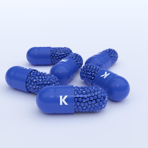Vitamine K Blue Capsules Granules en Whtie Achtergrond