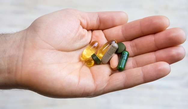 Photo vitamins and dietary supplements in a hand. selective focus. people.