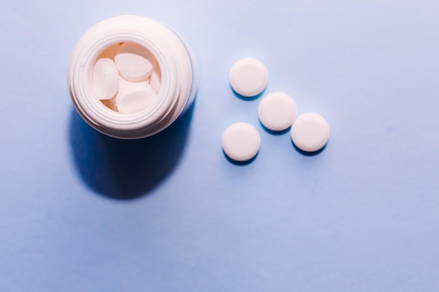 Vitamins large round calcium tablets on a paper background