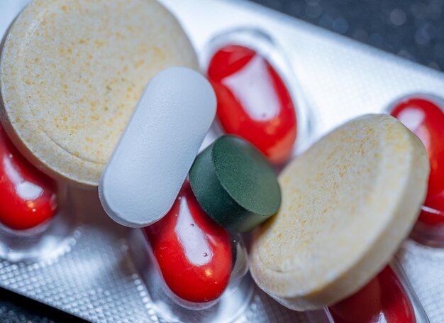 Photo vitamins and pills closeup on the table