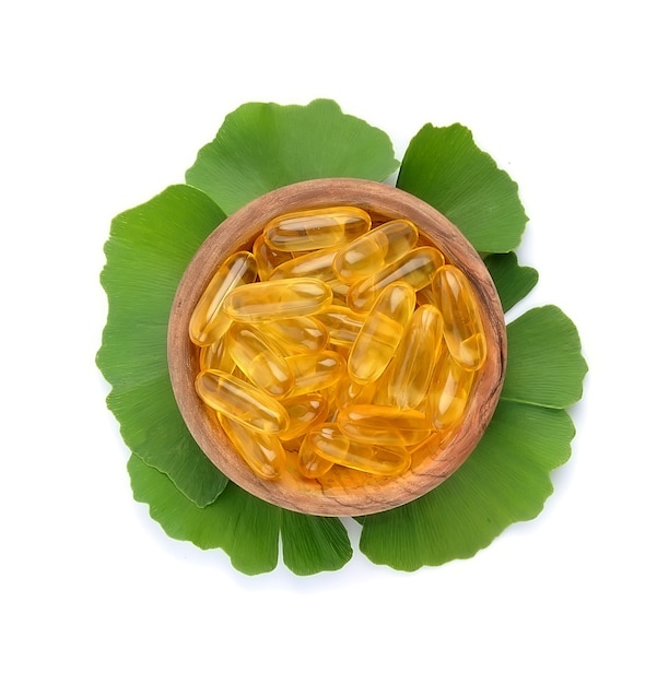 Photo vitamins with ginkgo biloba leaves isolated.