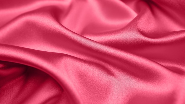 Viva magenta getinte rode magenta stoffen atlas. Close-up roze zijde satijn textuur voor naaien