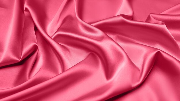 Viva Magenta toned red magenta fabric atlas. Close up pink silk satin texture for sewing