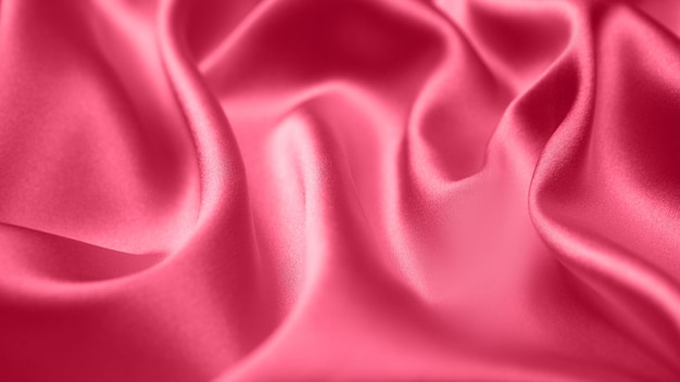 Viva Magenta toned red magenta fabric atlas. Close up pink silk satin texture for sewing