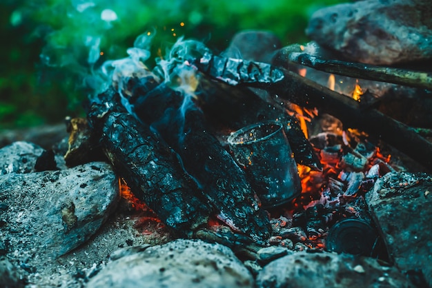 Vivid smoldered firewoods burned in fire closeup.