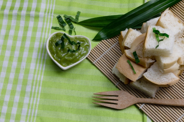 Vlabrood in houten dienblad en pandan deeg op groene doekvloer