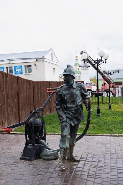 Vladimir Russia April 26 2023 Monument to a firefighter next to the rescue unit