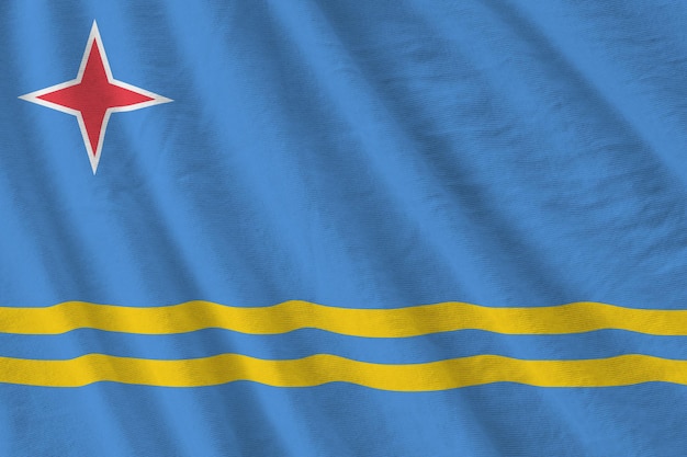 Vlag van Aruba met grote plooien die van dichtbij zwaaien onder het studiolicht binnenshuis De officiële symbolen en kleuren in banner