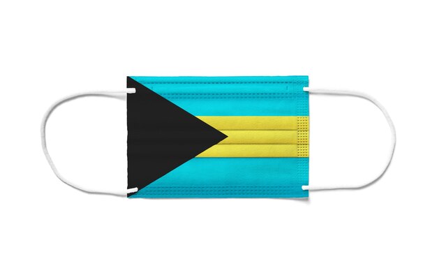 Vlag van Bahama's op een chirurgisch wegwerpmasker. Wit oppervlak geïsoleerd