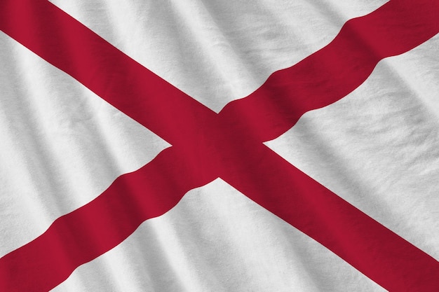 Foto vlag van de amerikaanse staat alabama met grote plooien die van dichtbij zwaaien onder het studiolicht binnenshuis de officiële symbolen en kleuren in banner