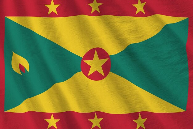 Vlag van Grenada met grote plooien die van dichtbij zwaaien onder het studiolicht binnenshuis De officiële symbolen en kleuren in banner