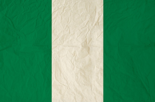 Vlag van Nigeria met oude vintage papier textuur achtergrond