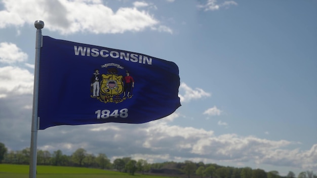 Foto vlag van wisconsin op een vlaggenmast zwaaiend in de wind blauwe hemel achtergrond 3d illustratie