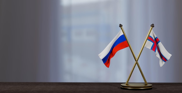 Vlaggen van Rusland en de Faeröer op tafel Onderhandeling tussen de Faeröer en Rusland op weinig wazige achtergrond 3D-werk en 3D-beeld