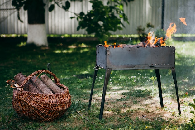 Vlammende barbecuegrill in de tuin in zomer