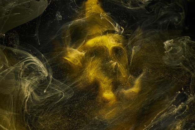 Vloeibare vloeistof kunst abstracte achtergrond Zwart geel dansen acrylverf onderwater ruimte rook oceaan