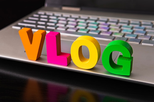 Vlog or video blog concept with vlog word from funny letters on the background computer keyboard