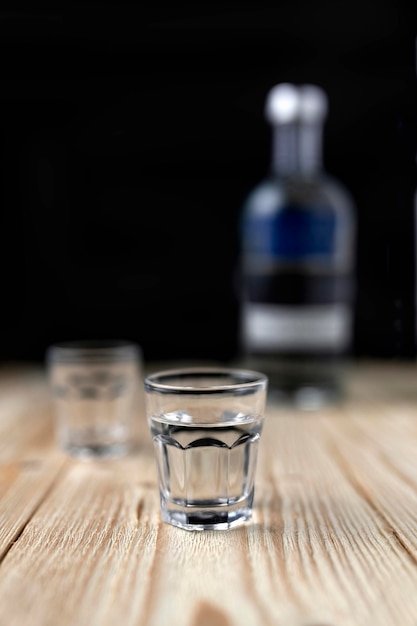vodka in a glass on a wooden table closeup alcohol