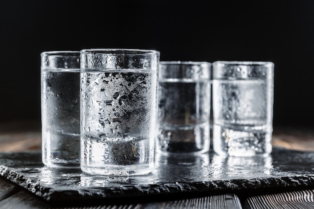 Vodka in  glasses on rustic wood 