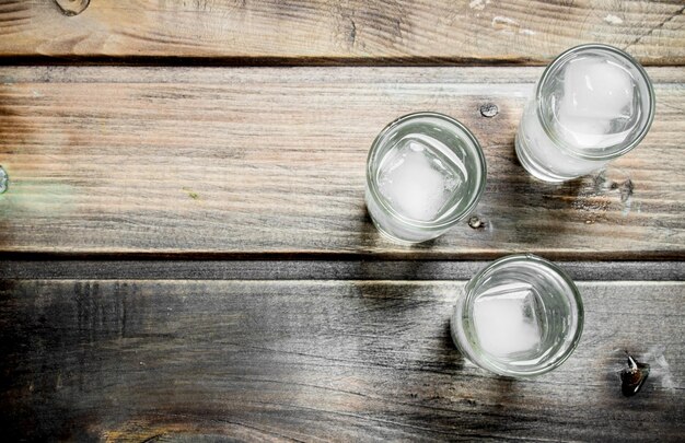 Vodka in a shot glass and ice cubes