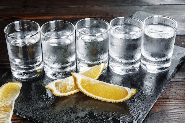 Vodka in shot glasses on rustic wood