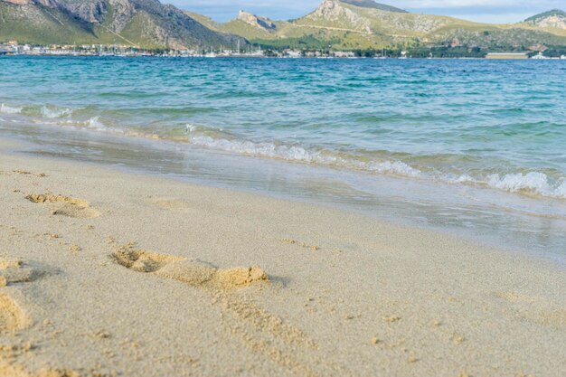 Voetafdrukken in het zand van een strand aan de Middellandse Zee op het eiland Ibiza in Spanje, vakantie- en zomerscène