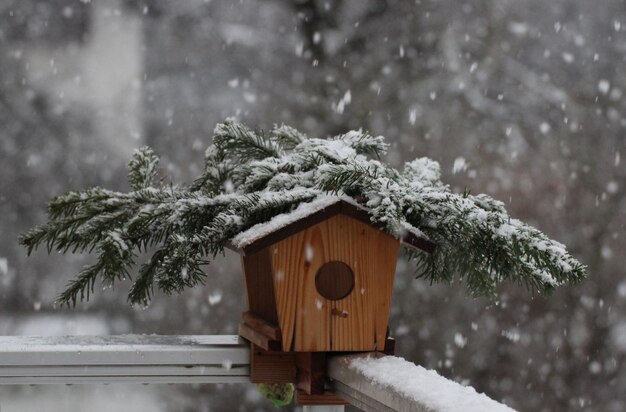 Foto vogelhut op het balkon tijdens sneeuwval