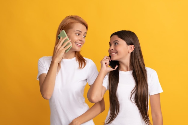 Voice contact happy woman and girl talk on smartphone family connection mobile communication technology mother and daughter speak on phone Always available mom and kid making phone call