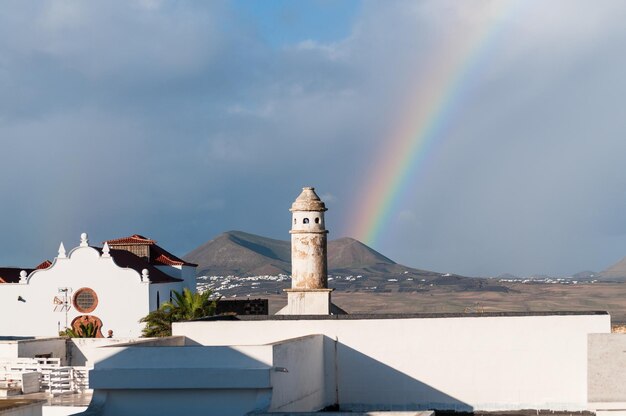 Volcanic landscape of Teguise in Lanzarote in the background the rainbow and a volcano