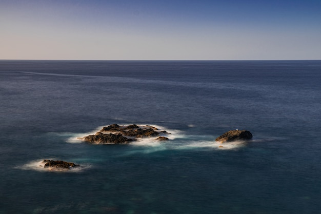 Photo volcanic rocks in atlantic ocean, san juan de la rambla coastline, tenerife, canary islands, spain