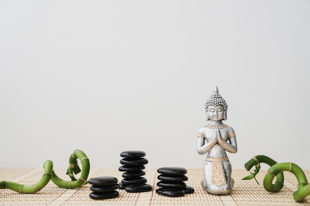 Photo volcanic stones, bamboo sticks and buddha figure