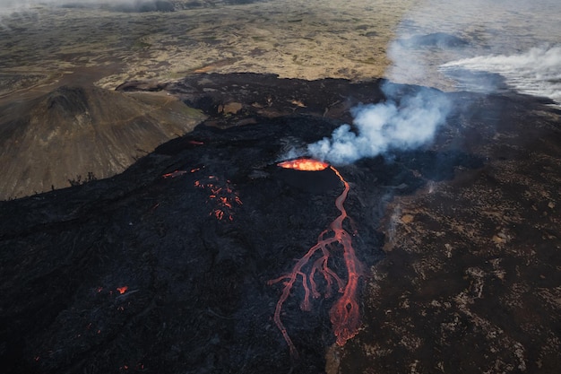 Volcano eruption in iceland summit crater gas expulsion and molten lava spilling out from a vent