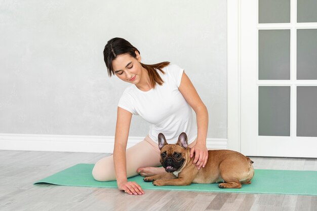 Volledig geschoten tiener en hond op yogamat