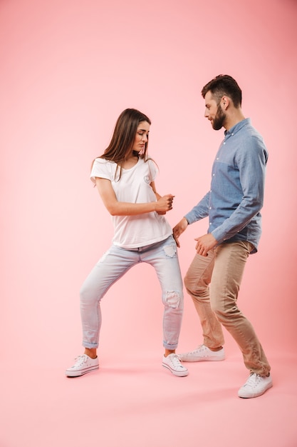 Volledig lengteportret van een vrolijk jong paar dansen