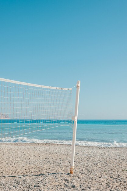 Photo volleyball net on a dreamy beach with no people and copy space