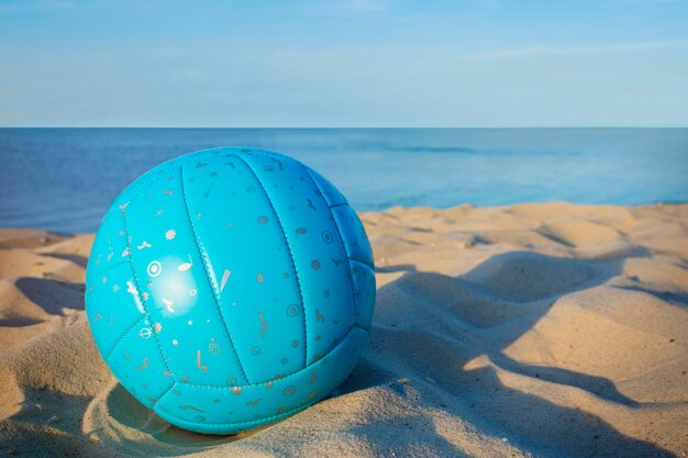 Volleyball in the sand with sandals at the beach