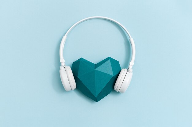 Volumetric paper heart in white headphones.