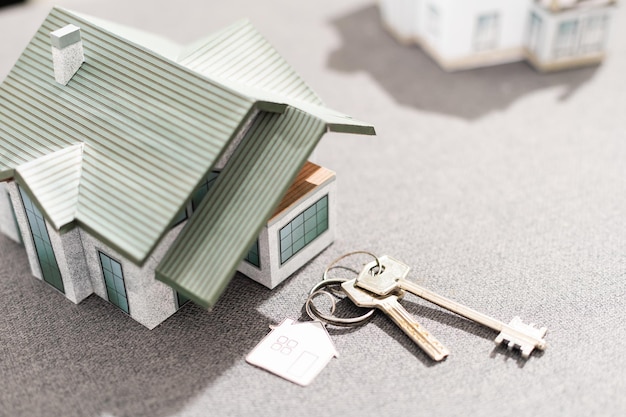 Volumetric project of house. Layout of a house with an open roof. Miniature layout of a cottage top view. Building model as a symbol of architectural business. Design in architectural bureau.