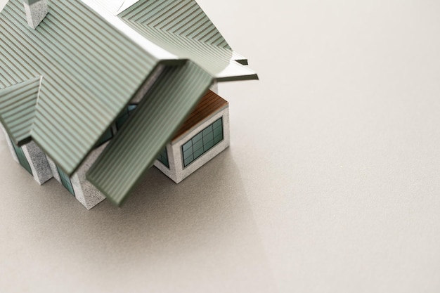 Volumetric project of house. Layout of a house with an open roof. Miniature layout of a cottage top view. Building model as a symbol of architectural business. Design in architectural bureau.