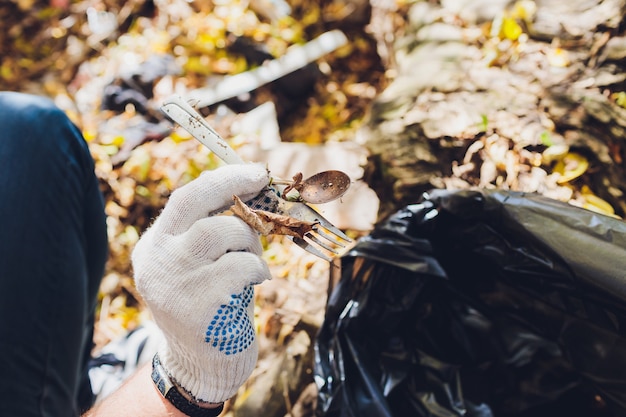 Volunteer cleans up trash in a park