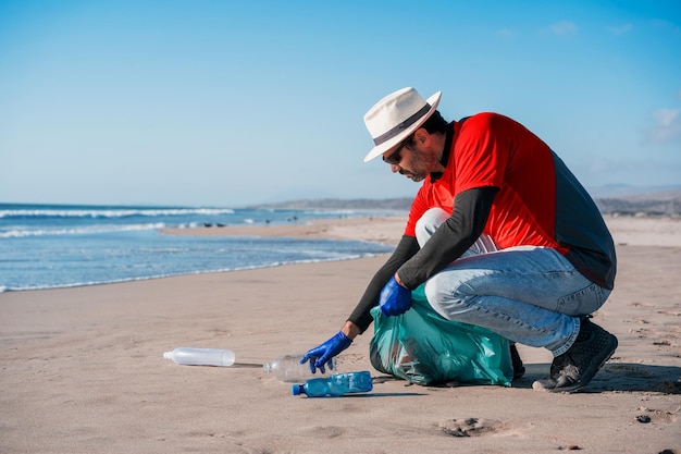 Volunteer collects plastic waste on the beachx9