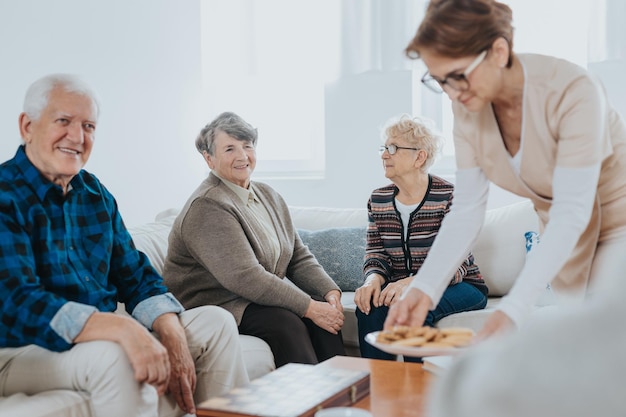 Volunteer helps seniors living in a care home for elderly