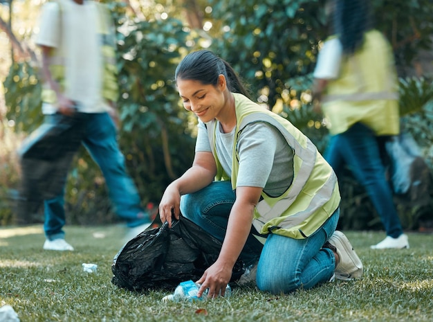 Volunteer recycle pollution cleaning charity group working together to collect trash for sustainability Community support sustainable and eco friendly people help to clean park grass outdoor