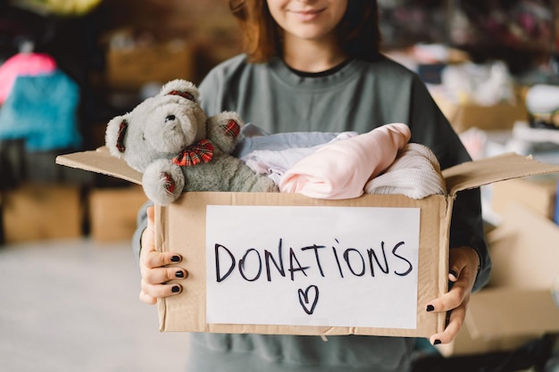 Volunteer teengirl preparing donation boxes for people