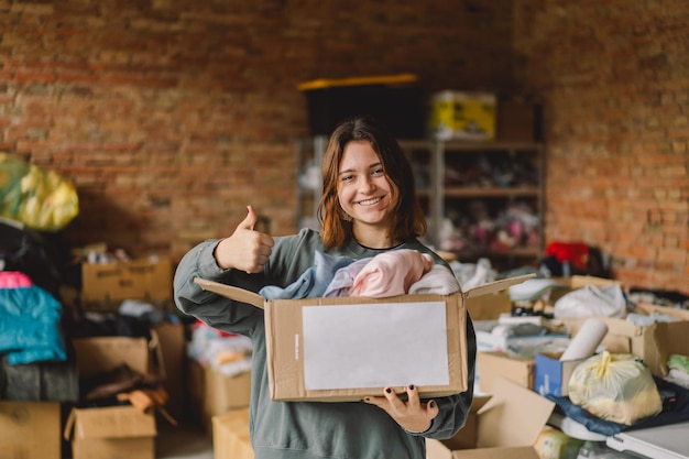 Volunteer teengirl preparing donation boxes for people