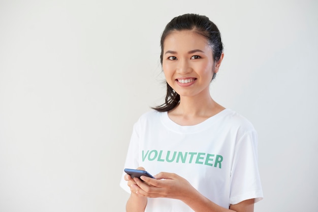 Volunteer using mobile phone in work