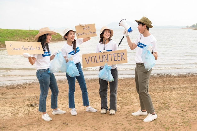 Volunteers from the Asian youth community using rubbish bags cleaning up nature par