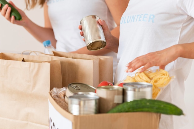 Volunteers preparing bag with provisions for donation