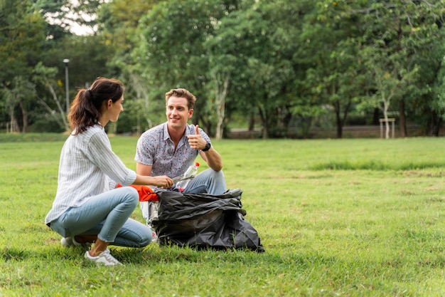 Volunteers wearing gloves and picking up the garbage in the park